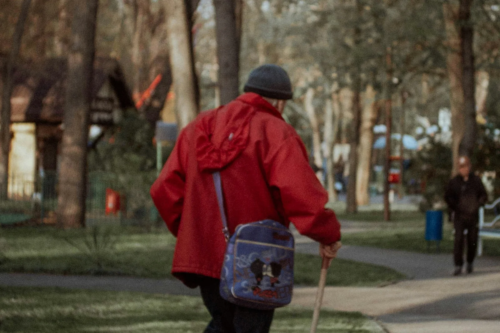 Man over 50 walking through a green park