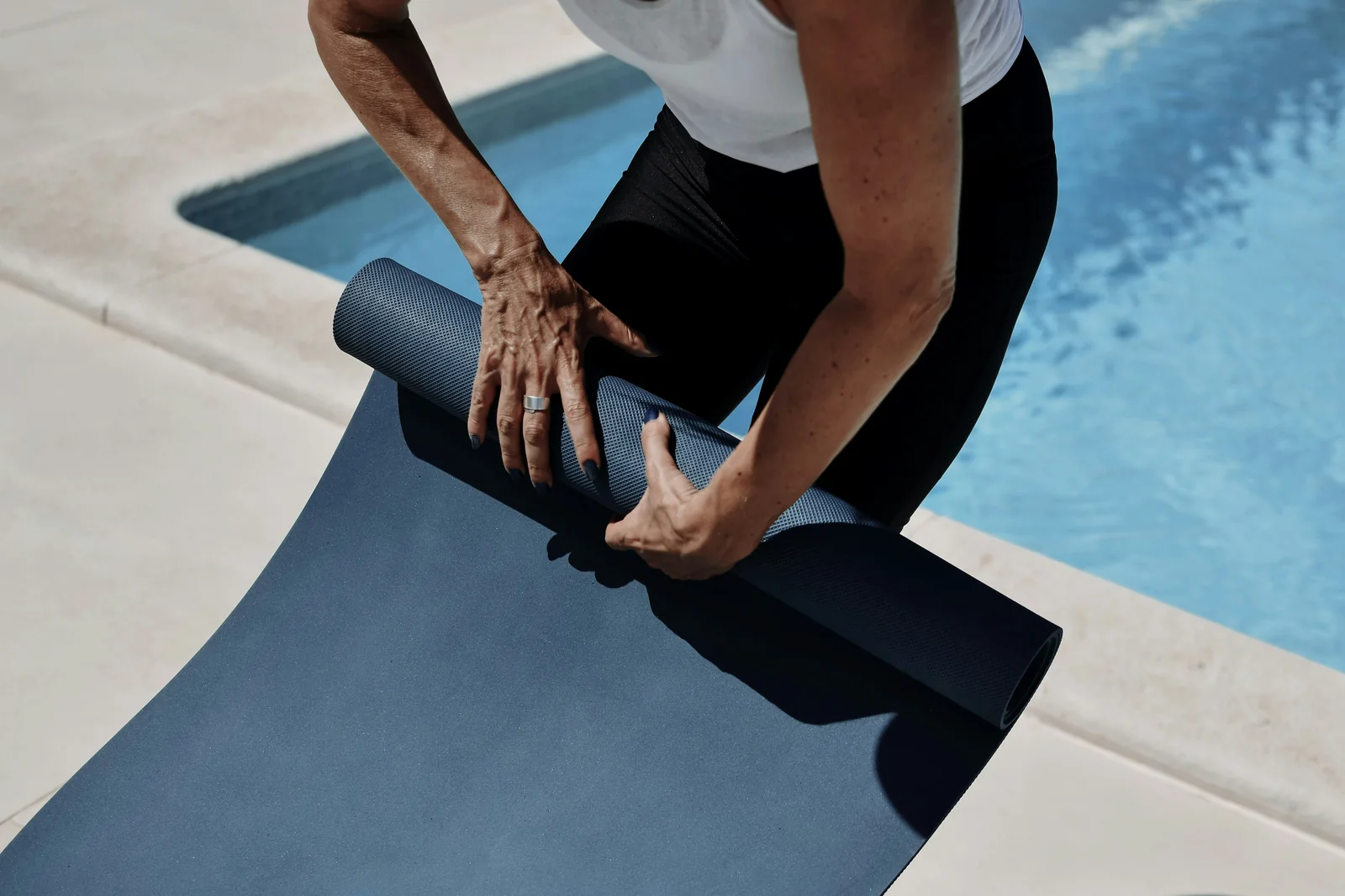Mature man preparing a yoga mat at home